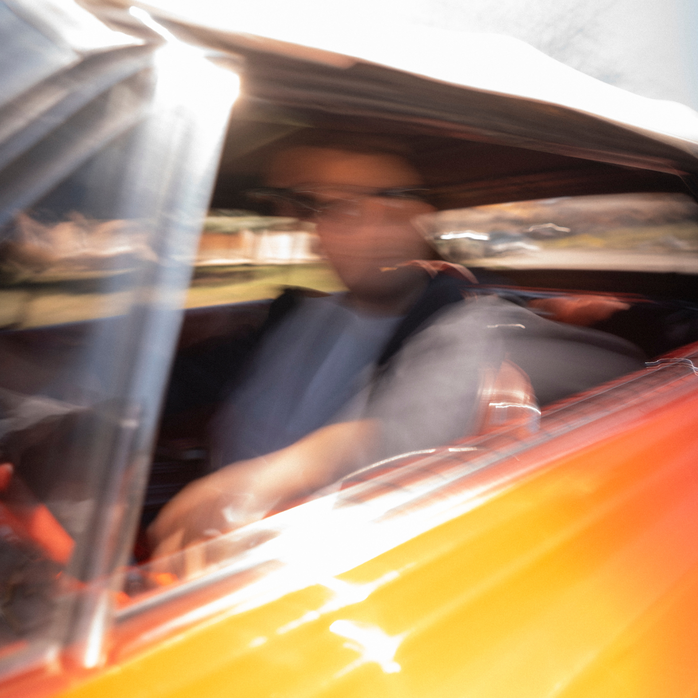 Nicholas Petrungaro in a moving classic red car on the I'm Gone single cover